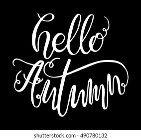 Hand drawn typography lettering phrase "hello autumn" isolated on the black background. Fun calligraphy for typography greeting and invitation card.