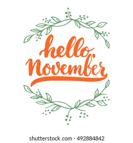 Hand drawn typography lettering phrase Hello, November isolated on the white background with green wreath leaves. Fun brush ink calligraphy inscription for greeting and invitation card or print design