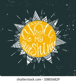 Hand drawn typography poster with sun and tribal ethnic ornament . Conceptual handwritten phrase You are my sunshine.  T shirt hand lettered calligraphic design. Inspirational vector typography.