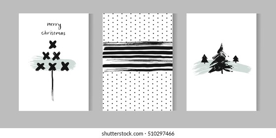Hand drawn vector abstract Christmas decoration cards set design with dirty brush painted Christmas trees and handwritten modern lettering phase Merry Christmas isolated on white background.