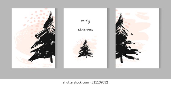 Hand drawn vector abstract Christmas decoration cards set design with dirty brush painted Christmas trees and handwritten modern lettering phase Merry Christmas isolated on white background.