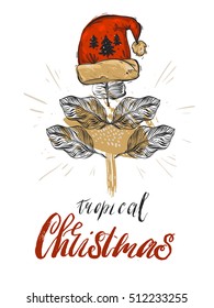 Hand drawn vector abstract graphic  greeting card decoration with tropical palm leaf,red Santa Claus hat and modern calligraphy phases tropical Christmas isolated on white .