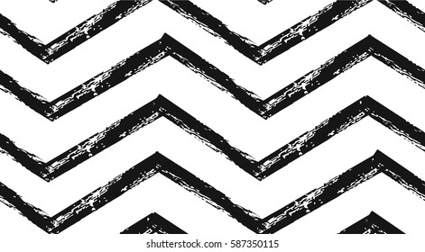 Hand drawn vector abstract rough geometric monochrome seamless zig zag chevron pattern in black and white colors.Hand made grunge brush painted texture.Scandinavian concept design for fashion,fabric