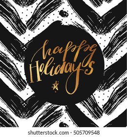 Hand drawn vector abstract textured Christmas greeting card template with handwritten golden modern lettering phase happy holidays and dirty brush stroked black texture.