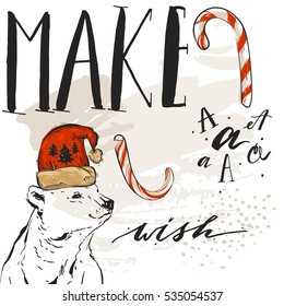 Hand drawn vector abstract textured Merry Christmas greeting card template with polar bear in red Santa hat,candy canes and modern lettering phase Make a wish isolated on white background.
