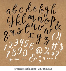 Hand drawn vector calligraphic English alphabet with numbers, ampersand and symbols written with brush pen. Craft paper background