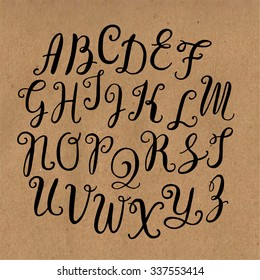 Hand drawn vector calligraphic English alphabet written with brush pen. Craft paper background