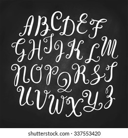 Hand drawn vector calligraphic English alphabet written with brush pen. Chalkboard background