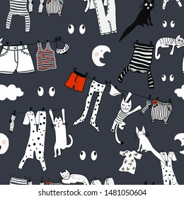 Hand drawn vector cute cartoon seamless pattern illustration colorful clothes on the rope, moon, eyes and sleeping cats on dark background.