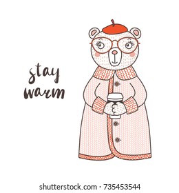 Hand drawn vector illustration of a cute funny bear in a knitted coat, beret and glasses, holding paper cup, text Stay warm. Isolated objects on white background. Design concept for children.