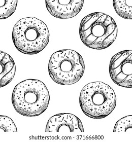  Hand drawn vector illustration - Seamless pattern with tasty donuts. Sketch. Sweet desserts