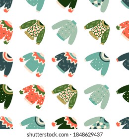 Hand drawn vector illustration of warm winter and autumn woolen sweaters in Scandinavian style, executed as vector seamless pattern. Trendy flat design elements for winter clothes. 