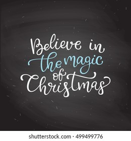 Hand drawn vector lettering Believe in the magic of Christmas. Isolated calligraphy on black chalkboard. Quote about winter and Christmas.