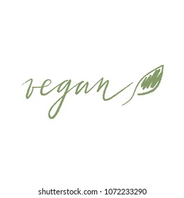 Hand drawn vector lettering isolated on the white background. hand written word: vegan with a green leaf.