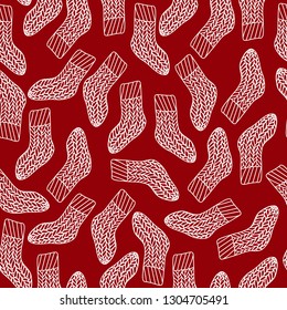 Hand drawn vector seamless pattern with winter socks. Cute winter ornament for fabric and wrapping paper.