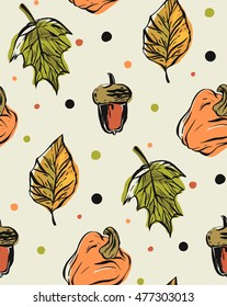 Hand drawn vector seamless pattern with autumn leaves fall,pumpkins and acorns on polka dot color background.