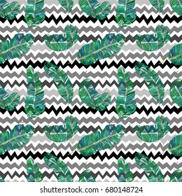 Hand drawn vector seamless pattern with banana tree leaves. Green colourful palm leaves background. Retro style. Textile print. Surface ornament.

