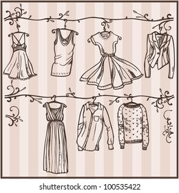 Hand drawn vector set of women's clothing on hangers. Sketch style