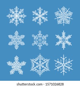 Hand drawn vector snowflakes isolated on blue background