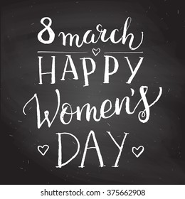 Hand drawn vector white  lettering "Women's day" on chalkboard