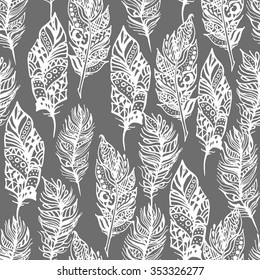 Hand drawn vector zentangle doodle white feathers seamless pattern on grey. Ethnic ink openwork tribal feathers, stylized for coloring pages in vintage boho style. Bohemian monochrome fabric print.