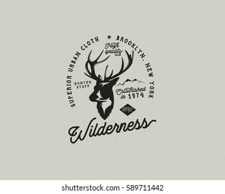 Hand drawn vintage camping badge and hiking label with hiking design elements and typography. Included deer head, mountains and quote text- "wilderness". Old style patch. Rustic patch vector template.