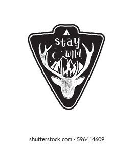 Hand drawn vintage camping badge and hiking label with wild animals design elements. Included deer head, mountains and quote text- "stay wild". Old style patch. Rustic stamp vector template