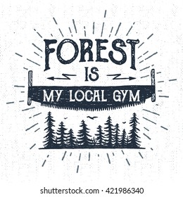 Hand drawn vintage label with textured saw vector illustration and "Forest is my local gym" lettering.