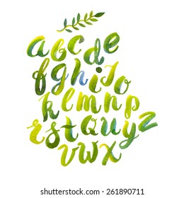 Hand drawn watercolor alphabet made with brush-shades and smears of spring leaves and flowers