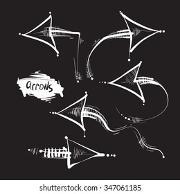 Hand drawn white arrows on black background