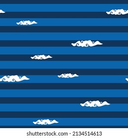 Hand drawn white clouds scattered on a background of blue and navy stripes. Seamless repeat vector pattern. Great for fashion, textiles, surface textures, giftwrap, wallpaper.