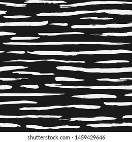 Hand drawn white ink stripe backdrop. Artistic brush stripes seamless pattern on black background. Vector illustration