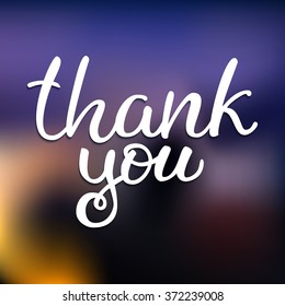Hand drawn white ink vector lettering "Thank you" on blue blurred background. 