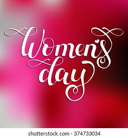 Hand drawn white ink vector lettering "Women's day" on pink blurred background. 