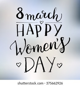 Hand drawn white ink vector lettering "Women's day" on gray blurred background. 