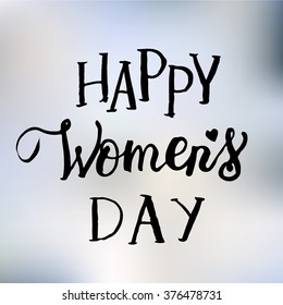 Hand drawn white ink vector lettering "Women's day" on green blurred background. 