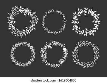 Hand drawn wreath for design use. White Vector doodle flowers on black background. Abstract pencil boho drawing branch circle. Artistic illustration elements plant and bloom