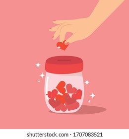 Mano deposita el corazón en la botella, Donación para ayudar al concepto de la gente. 