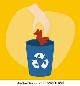 Hand dropping the trash paper to blue recycle bin