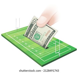 A hand drops a 20 american dollar bill in an american football field into a slot like a piggy bank