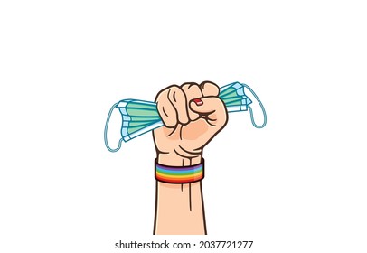 Hand with fist raised up high wearing rainbow colored wristband clenching medical mask tightly, symbol of protest, revolution, health equality, homosexual, LGBT, Human rights, pride month concept.