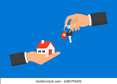 Hand giving house keys to customer. Businessman in suit giving house key. Mortgage, credit or property concept. Sale and rent of apartment. Buying a house. Sale and purchase concept