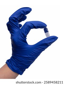 A hand in a glove holding a blue medical capsule. Medicine and treatment illustration. Medicaments and prescriptions.