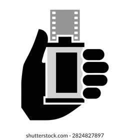 A hand grasping a film camera and film strip, symbolizing photography and creativity