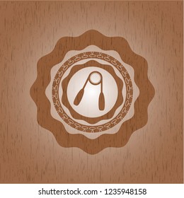 hand gripper icon inside badge with wooden background