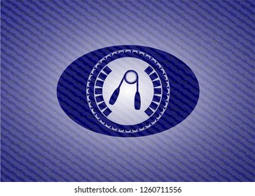 hand gripper icon inside badge with denim texture