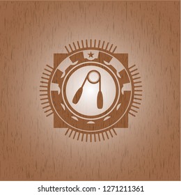 hand gripper icon inside badge with wood background