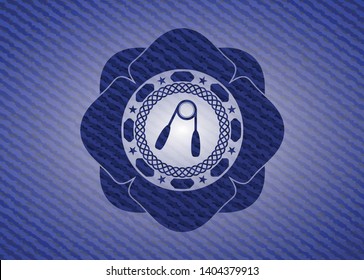 hand gripper icon inside badge with denim background