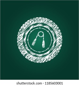 hand gripper icon inside chalk emblem written on a blackboard