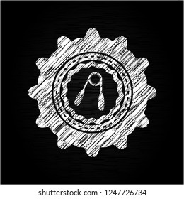 hand gripper icon inside chalkboard emblem written on a blackboard